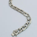 Silver chain bracelet on a light gray background