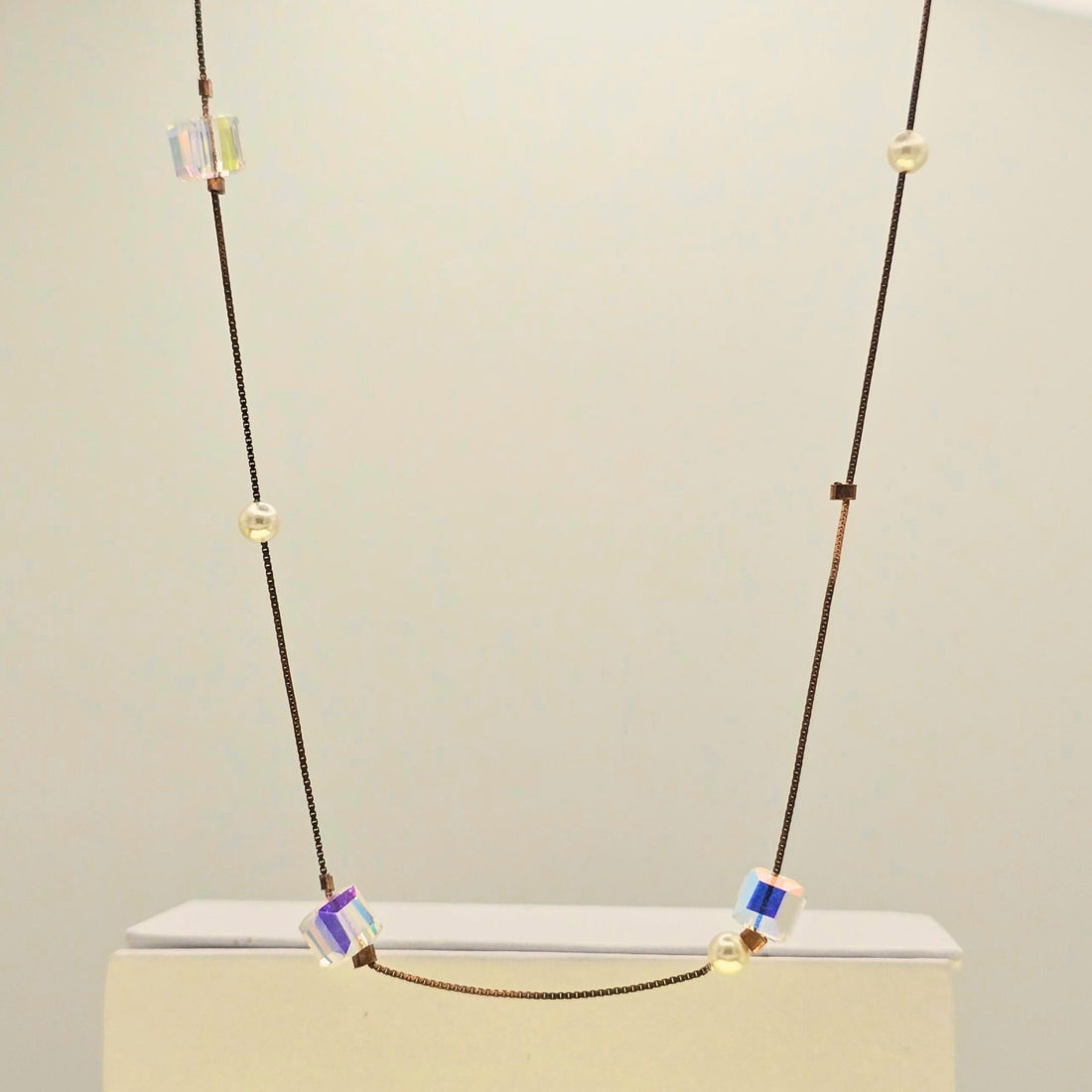 Necklace with colorful beads on a light gray background