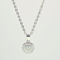 Silver necklace with a square pendant on a light gray background