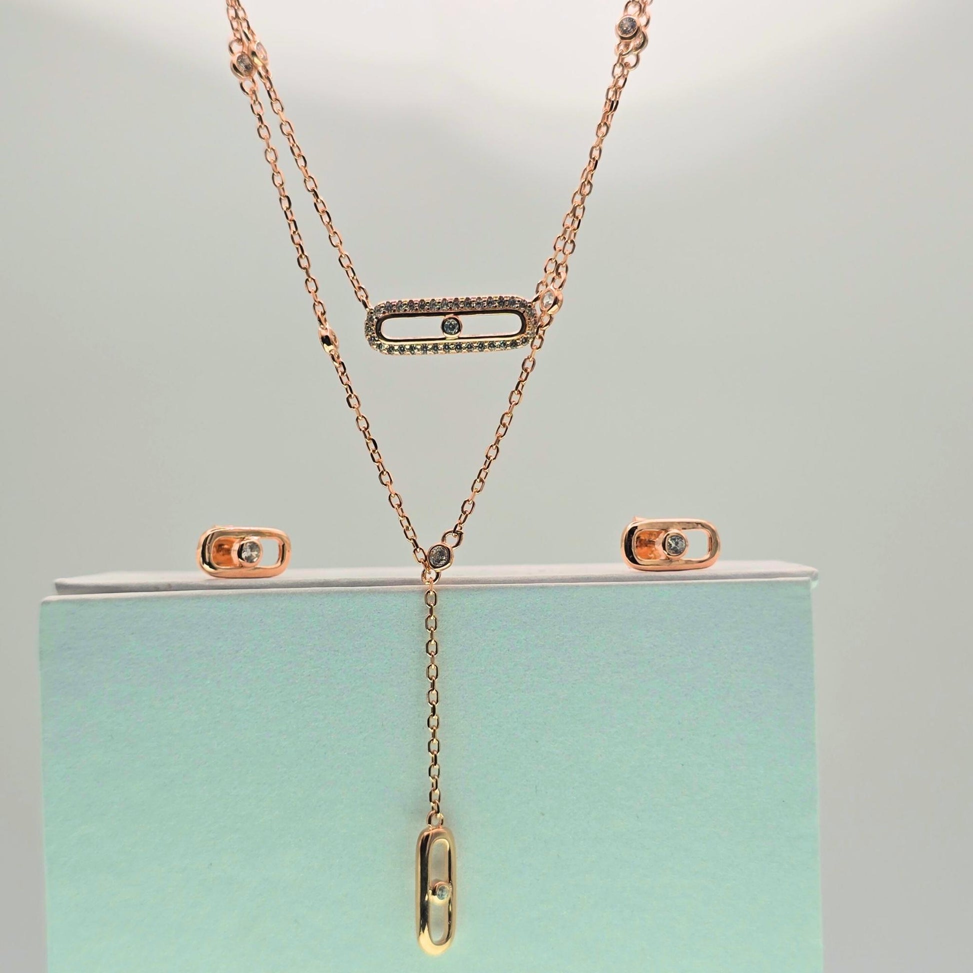925 silver rose gold jewelry set featuring a layered move pendant necklace and matching oval stud earrings for women.