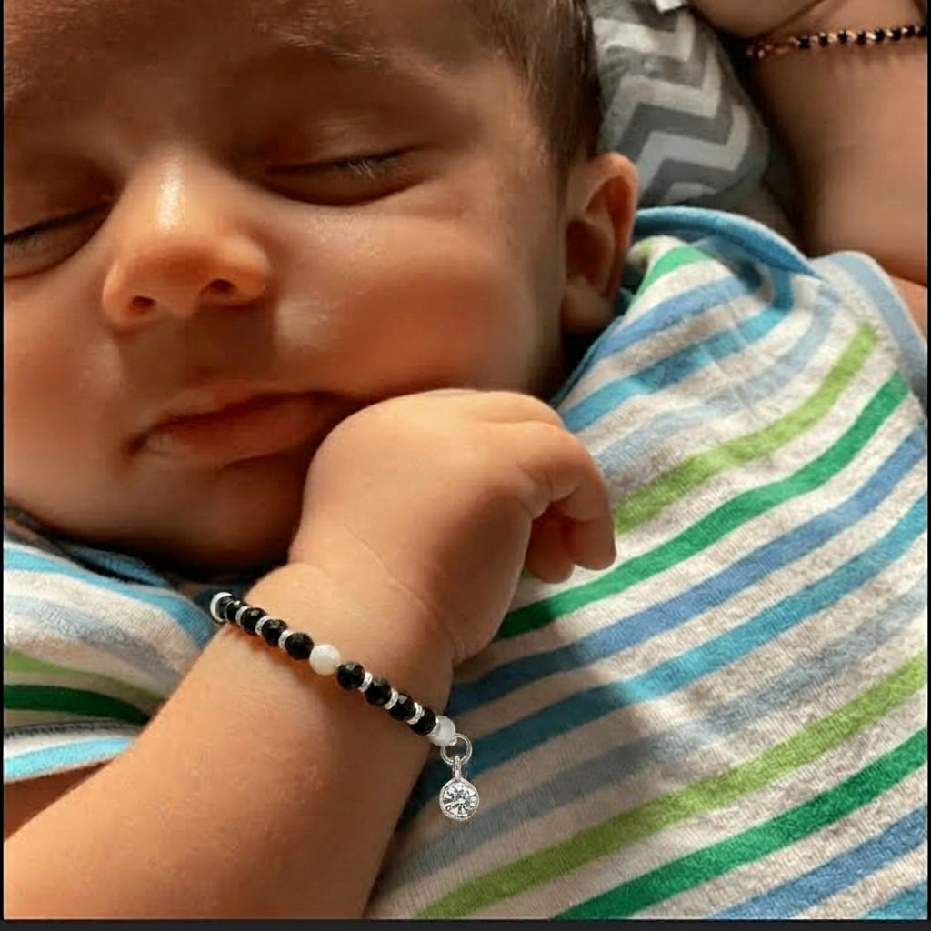 Set of black and white beaded necklaces with silver clasps on a white background