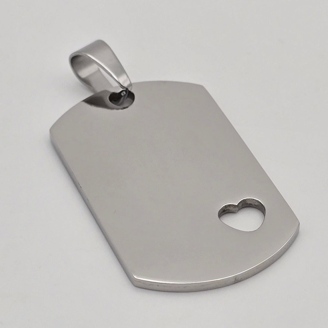 Custom name engraved dog tag necklace with heart cutout in silver-toned stainless steel waterproof and hypoallergenic premium personalized gift for couples and teens in USA Canada